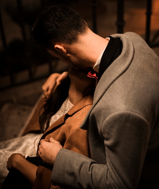 Young guy kissing lady on steps 