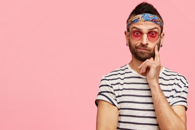 Young guy wearing bandana and stylish sunglasses