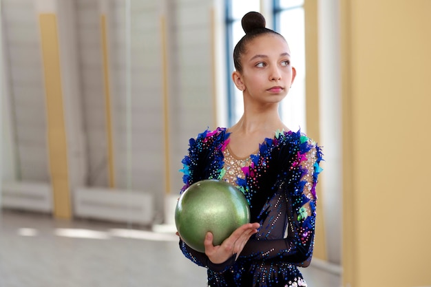 Free photo young gymnast at the gym with ball