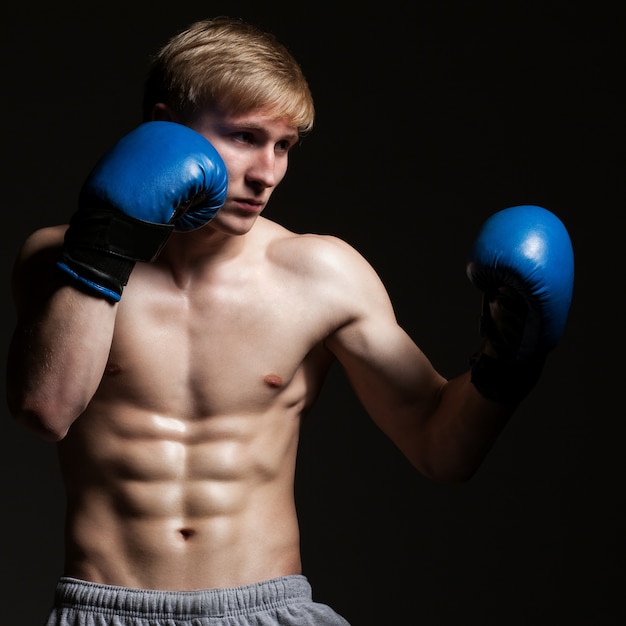 Young handsome boxer in a movement