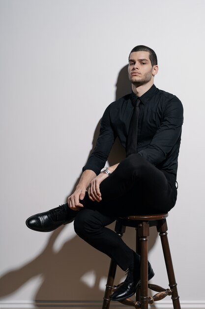 Young handsome businessman in black shirt and black suit