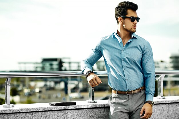  young handsome businessman model man in casual cloth in sunglasses in the street