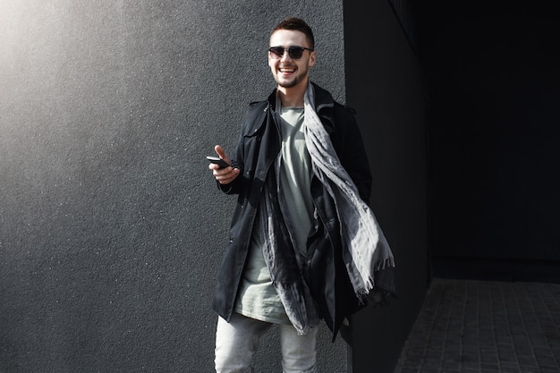 Free Photo young handsome guy in cool spring outfit standing in street.