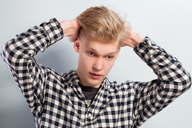 Free Photo young handsome guy with hand on head