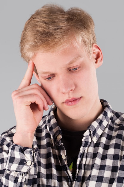 Young handsome guy with hand on head