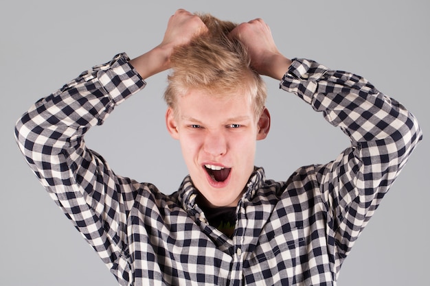 Young handsome guy with hand on head