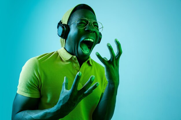 young handsome hipster man listening music with headphones