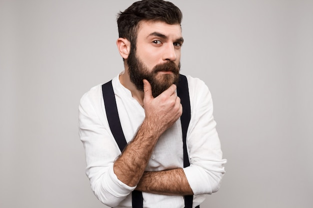 Young handsome man posing over white.