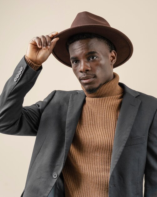 Young handsome man posing with hat