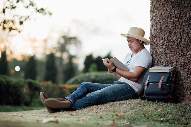 Young Handsome man relaxing on green grass