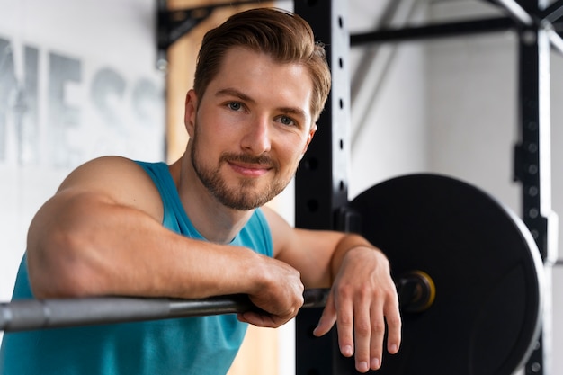 Young handsome man training at the gym for bodybuilding