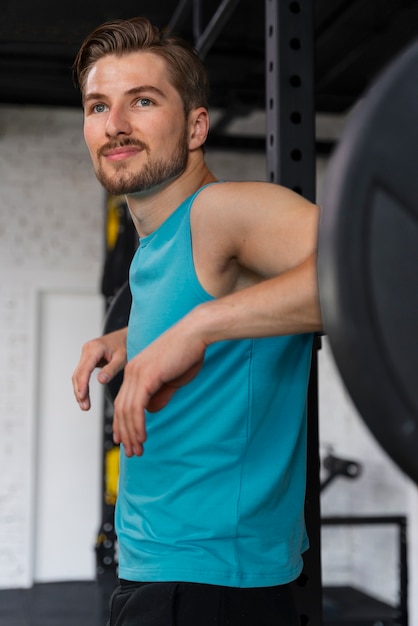 Free Photo young handsome man training at the gym for bodybuilding