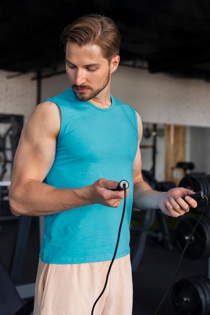 Young handsome man training at the gym for bodybuilding