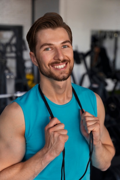 Young handsome man training at the gym for bodybuilding