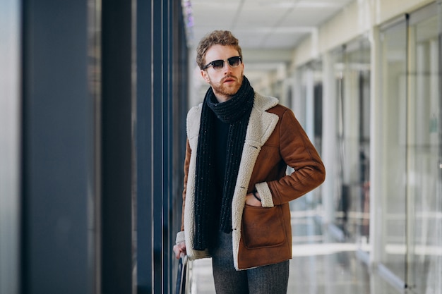 Young handsome man travelling with bag