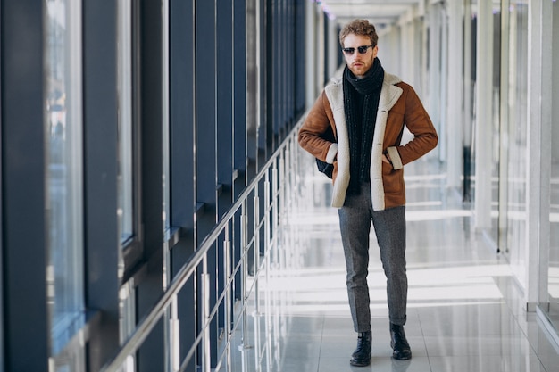 Free photo young handsome man travelling with bag