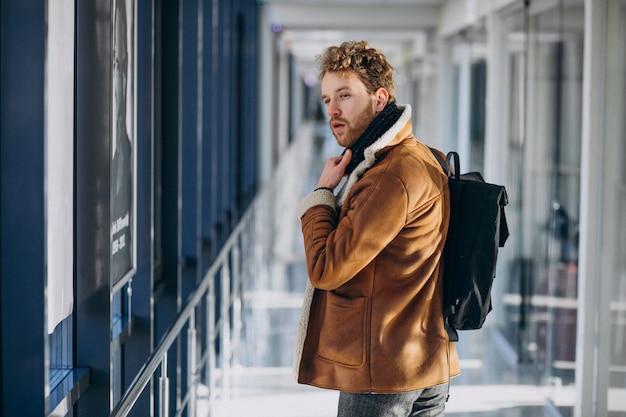 Young handsome man travelling with bag