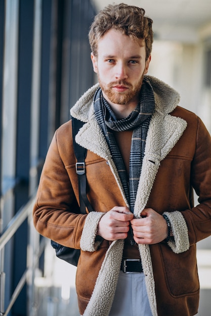 Free Photo young handsome man travelling with bag