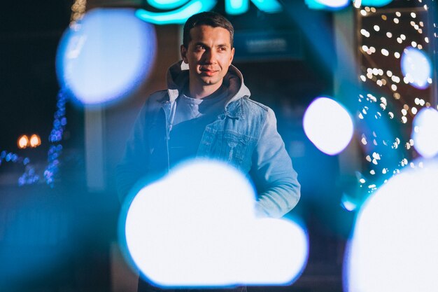 Free Photo young handsome man walking at evening outside the street