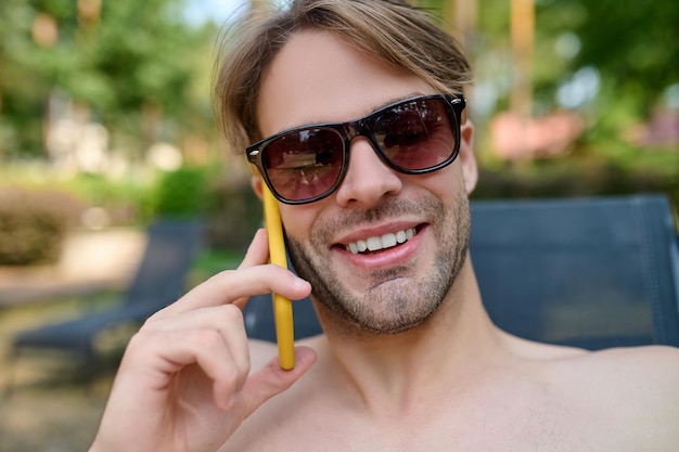 Young handsome man with a phone in hand