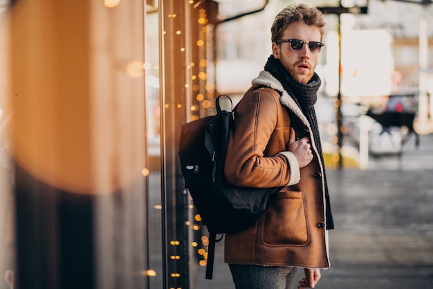 Young handsome man with winter clothes and backpack