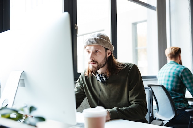 Young handsome man work in office using computer