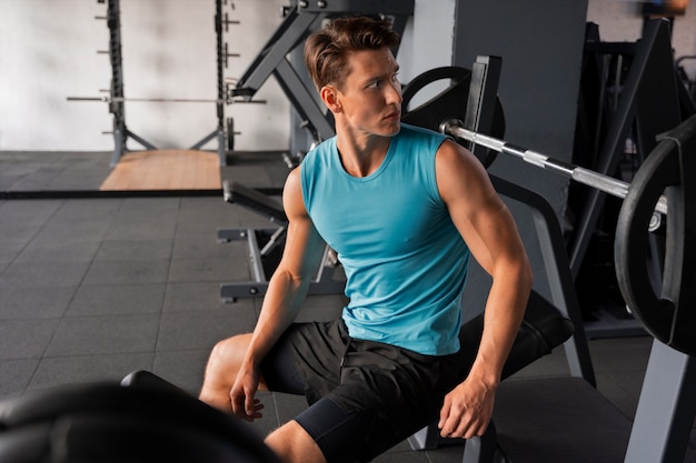 Free photo young handsome man working out at the gym for bodybuilding