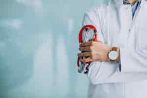 Free photo young handsome physician in a medical robe with stethoscope