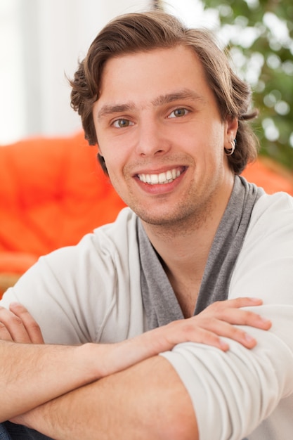 Young happy caucasian man at home 