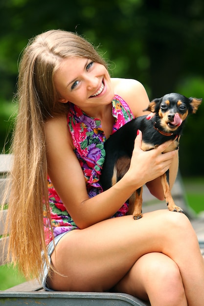 Free photo young and happy girl with her cute dog