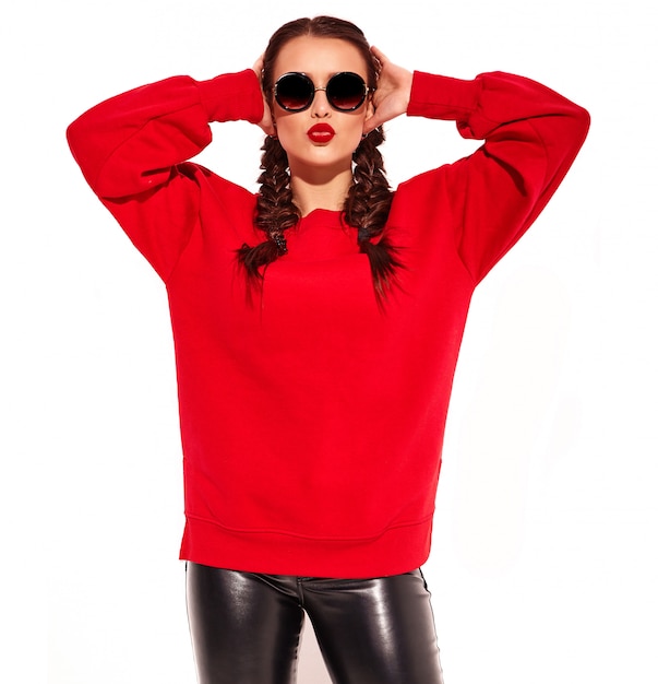 young happy smiling woman model with bright makeup and colorful lips with two pigtails and sunglasses in summer red clothes isolated. giving air kiss