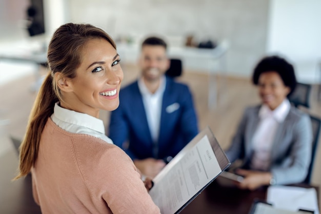 Free photo young happy woman having an job interview in the office