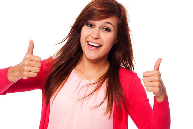 Young happy woman showing thumbs up