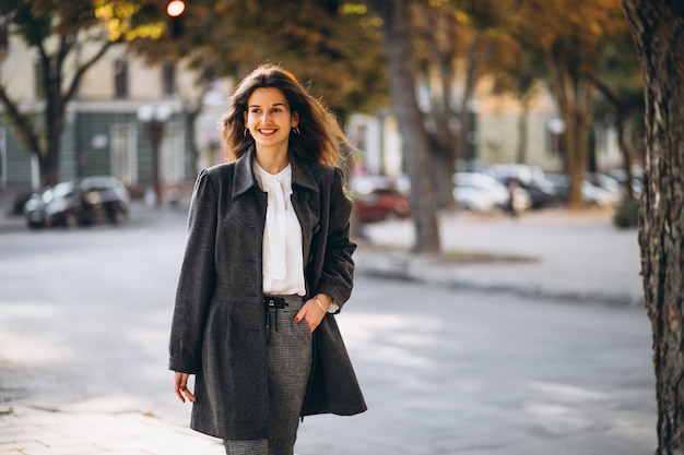 Young happy woman walking in the street