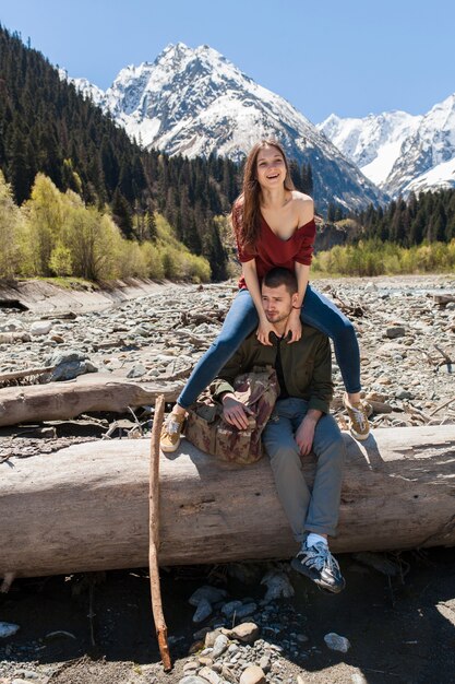 Young hipster beautiful couple hiking at river in forest