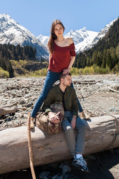 Young hipster beautiful couple hiking at river in forest