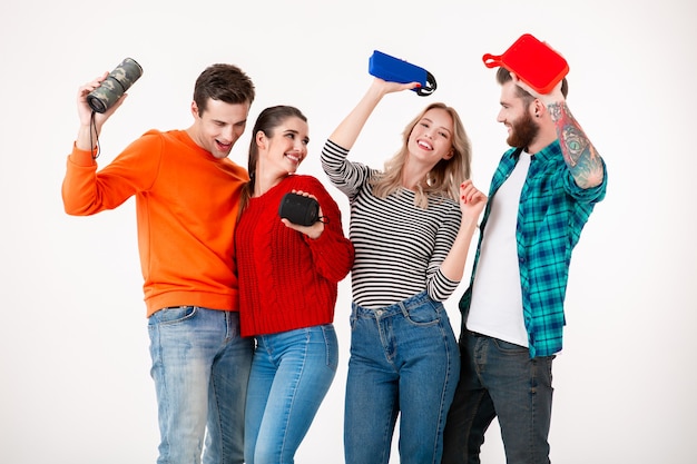 Young hipster company of friends having fun together smiling listening to music on wireless speakers