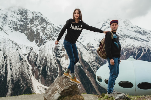 Young hipster couple in love walking in mountains