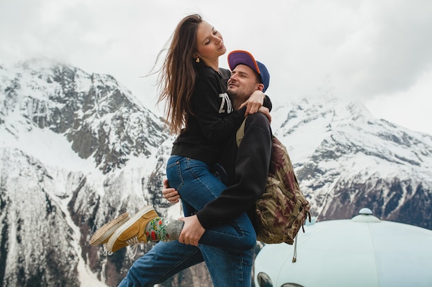 Free photo young hipster couple in love walking in mountains