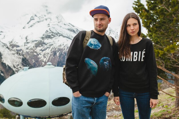 Young hipster couple in love walking in mountains