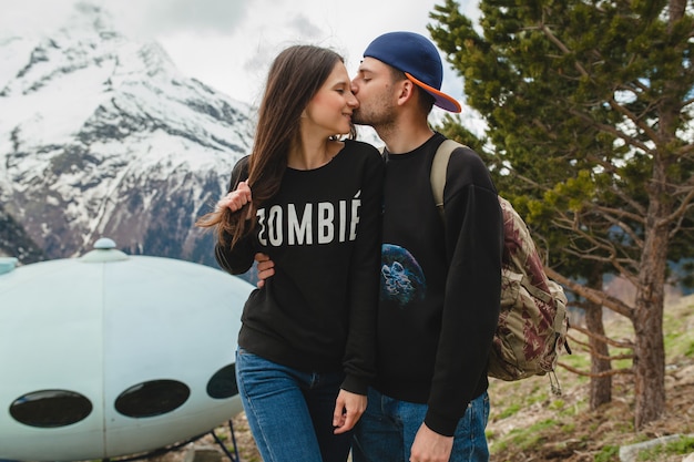 Free photo young hipster couple in love walking in mountains