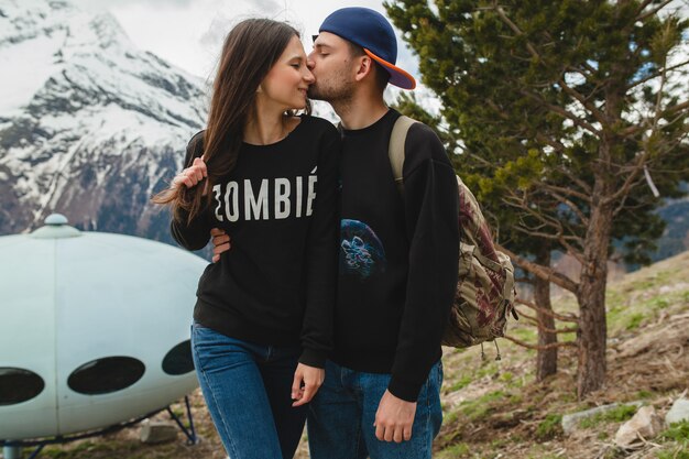 Free photo young hipster couple in love walking in mountains