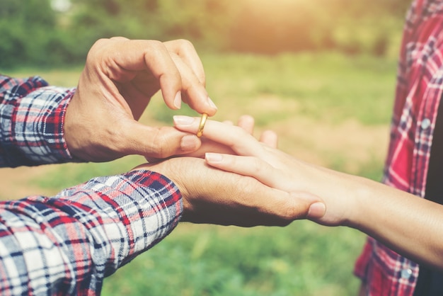 Young hipster couple wearing engagement ring in nature,Sweet and