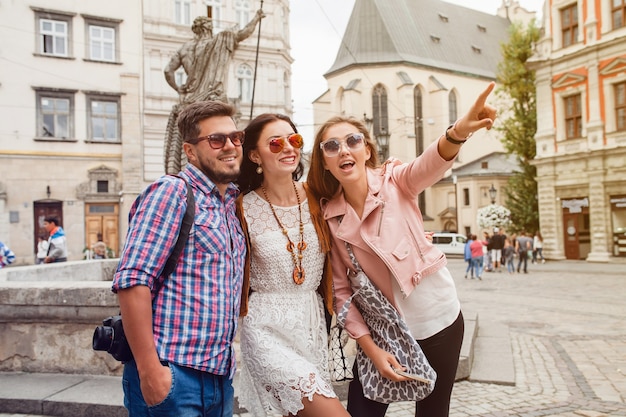 Young hipster friends posing in old town