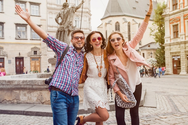 Young hipster friends posing in old town