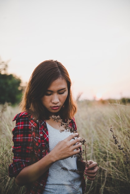 Young hipster girl in the summer field.