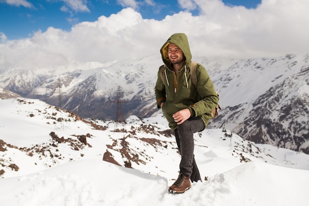 Free photo young hipster man hiking in mountains, winter vacation traveling