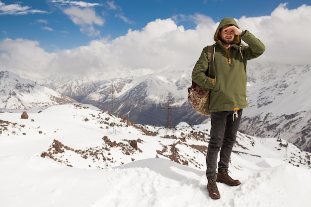 Free photo young hipster man hiking in mountains, winter vacation traveling