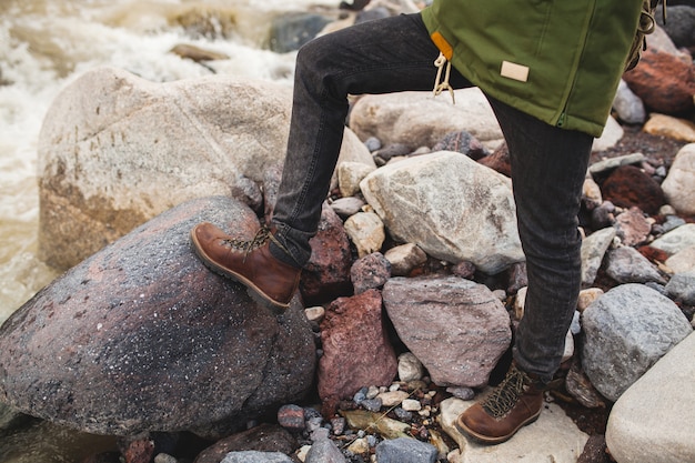 Free photo young hipster man, hiking in wild nature, winter vacation, traveling, warm shoes, boots close up, details feet, legs