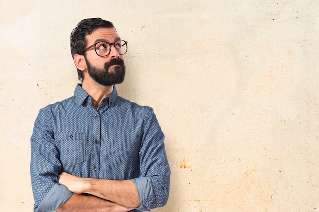 Free photo young hipster man thinking over white background